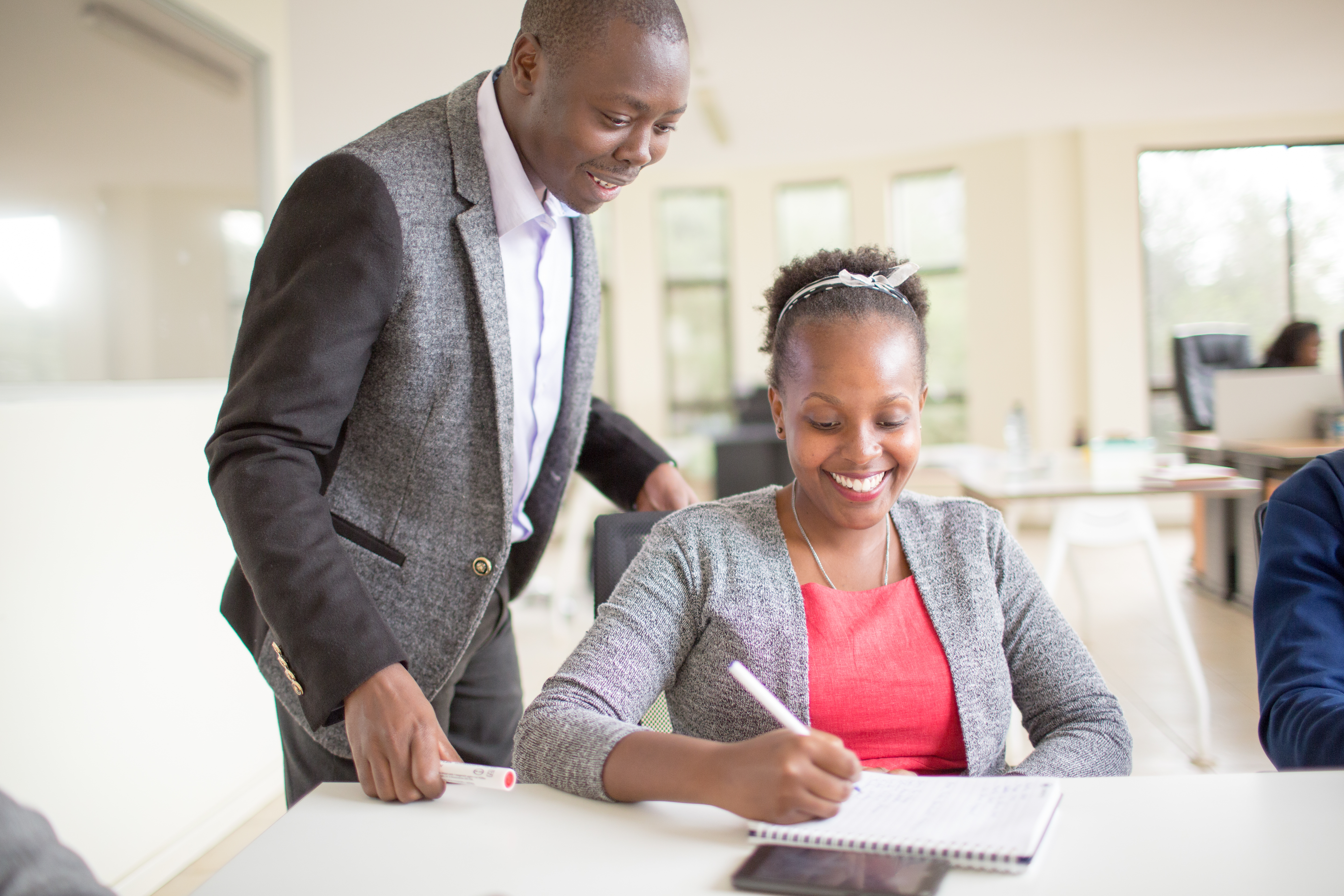 A group of young African professionals engaged in a collaborative discussion at the African Management Initiative, showcasing professional development and leadership training in action